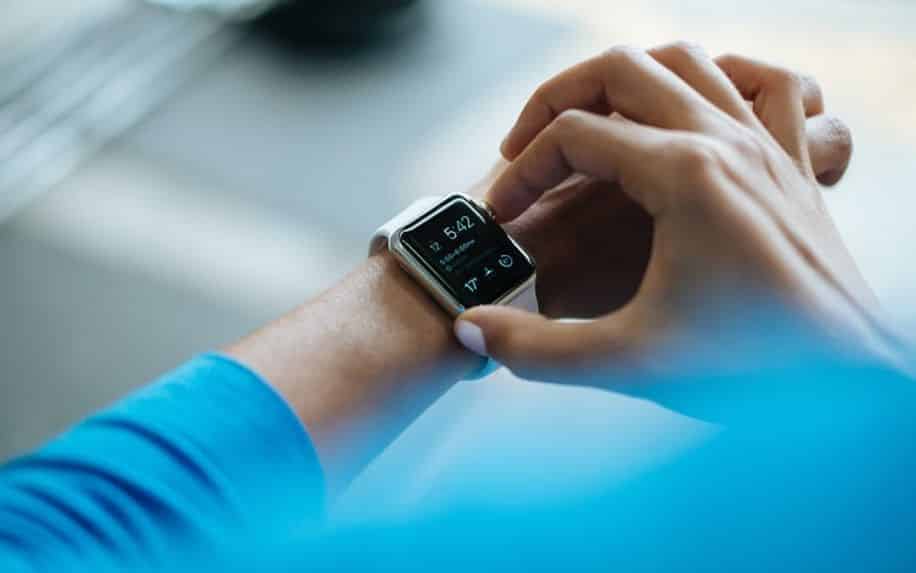 person checking their digital watch after a workout