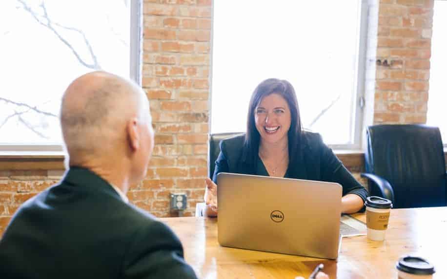 man and woman at a meeting