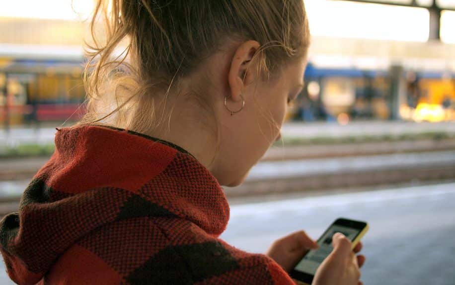 woman scrolling through interactive content on her phone