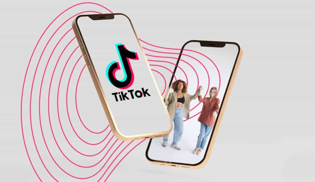 Grey background with two phones hovering - one with the TikTok logo and another with two women dancing