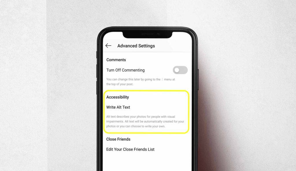 Grey background, black phone with a paragraph explaining alt text accessibility on Instagram with a yellow circle around it