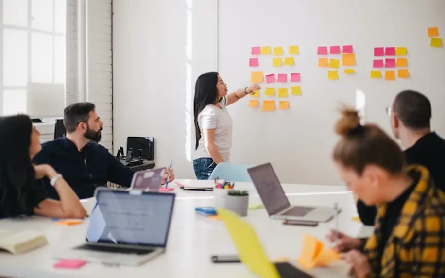 Image of a team meeting formulating a plan to denote integrated communications.