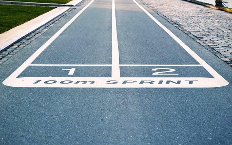 Image of two lanes of a running track to denote competition.