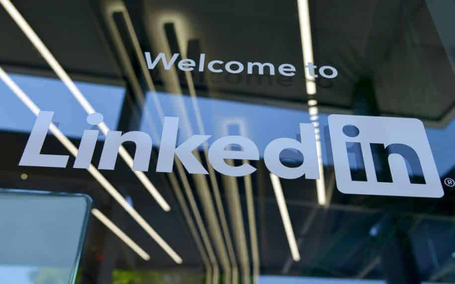 A photo of the LinkedIn logo on the window outside their office headquarters.