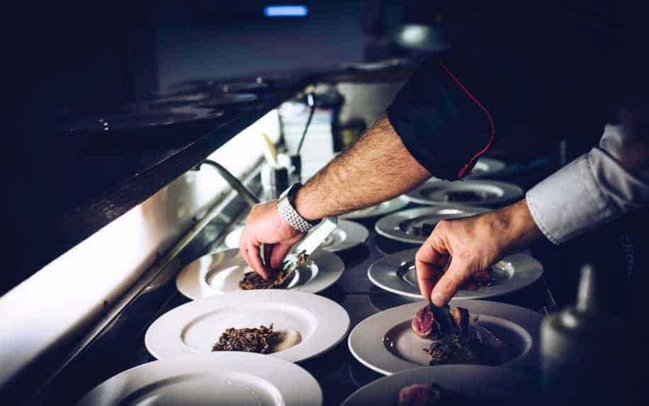 Two chefs plating in the kitchen