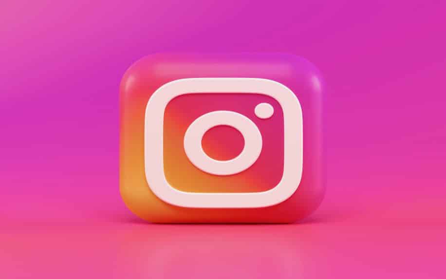 A 3D render of the Instagram logo with a pink background