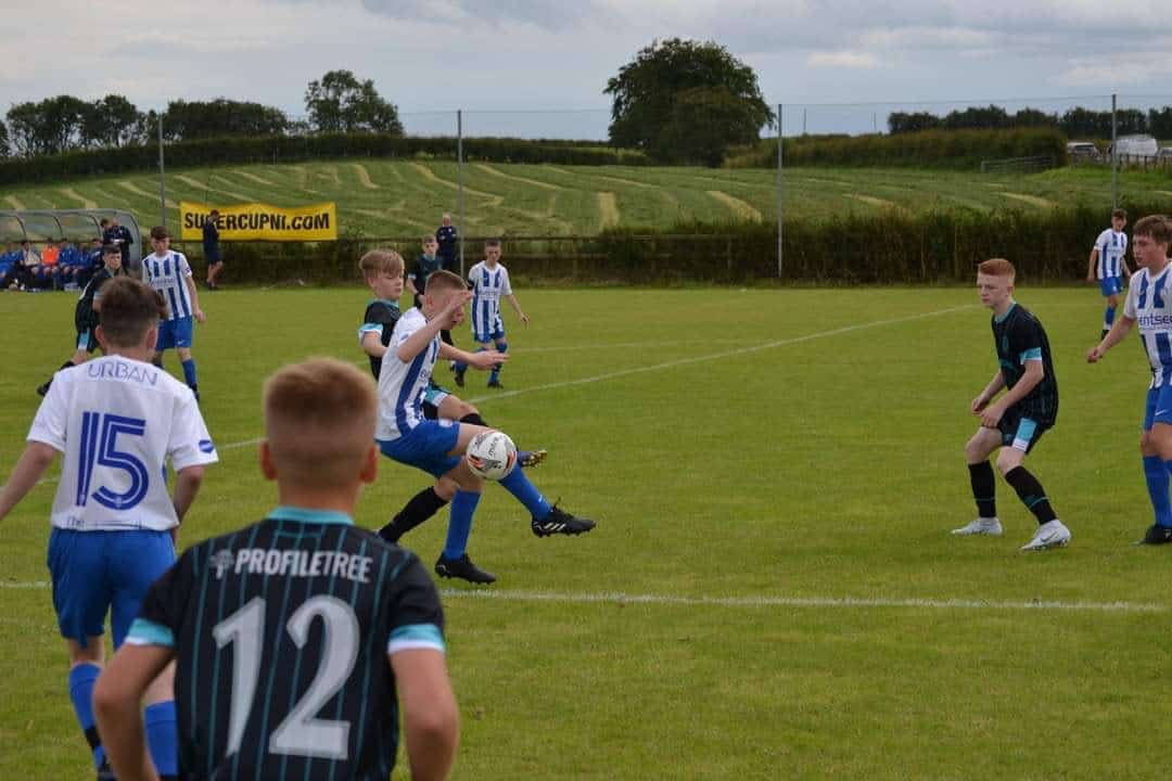 Photograph of Linfield Youth Team on Football pitch with ProfileTree branded jerseys