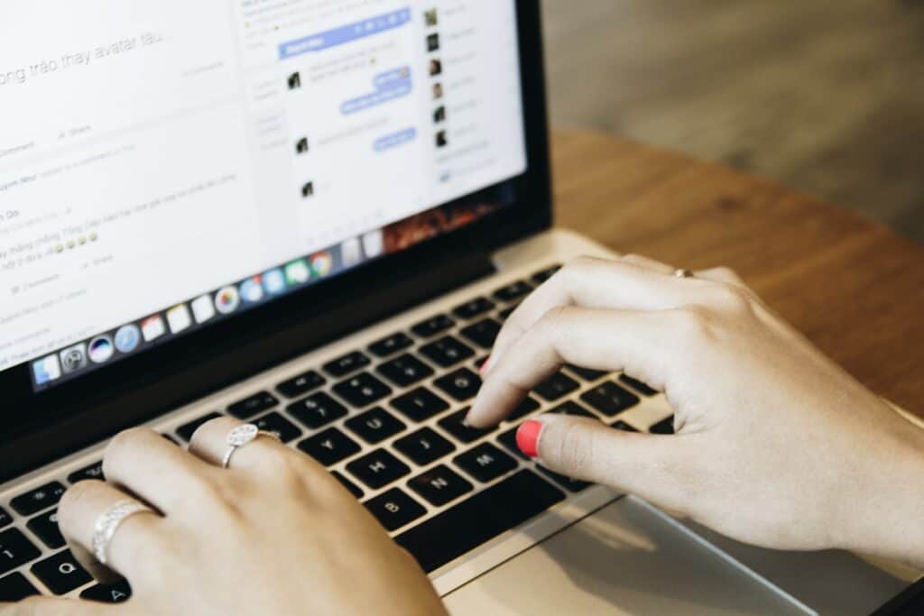 Photograph of Woman's Hands Using Laptop