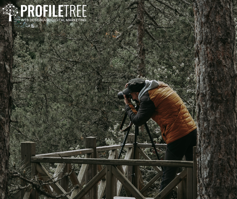 Vlogging Accessories - Man behind a camera placed on a tripod in the middle of the woods