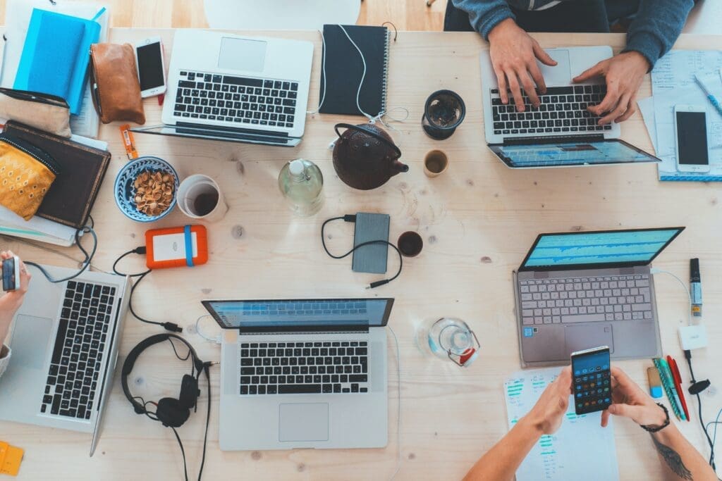 Laptops together at a desk: digital marketing examples