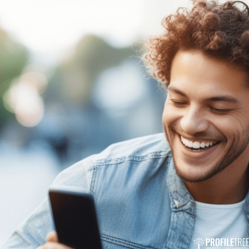 Image of man smiling at his phone