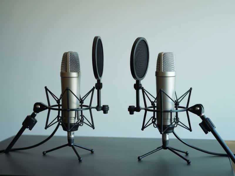 Two microphones set up for an interview recording session for businesses that start a podcast with guests