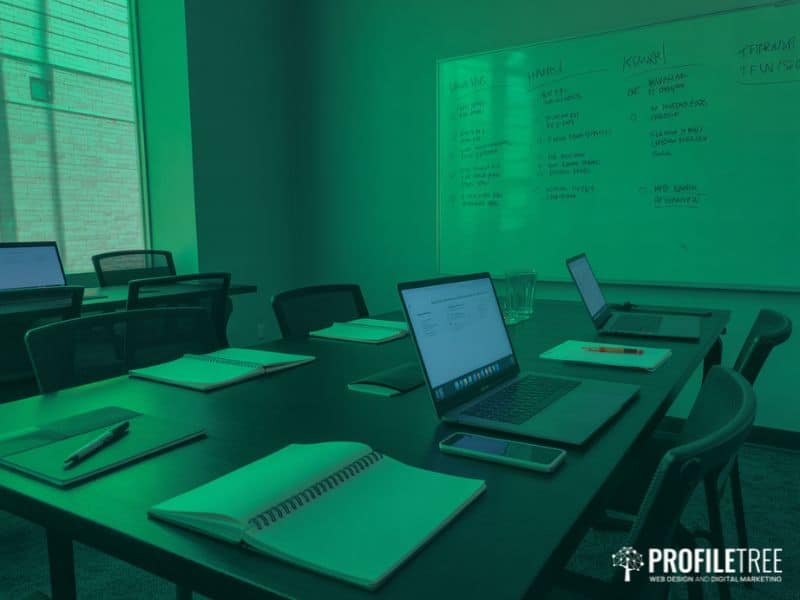 Social media training workshop room set up with a whiteboard laptops and notebooks ready for a team session