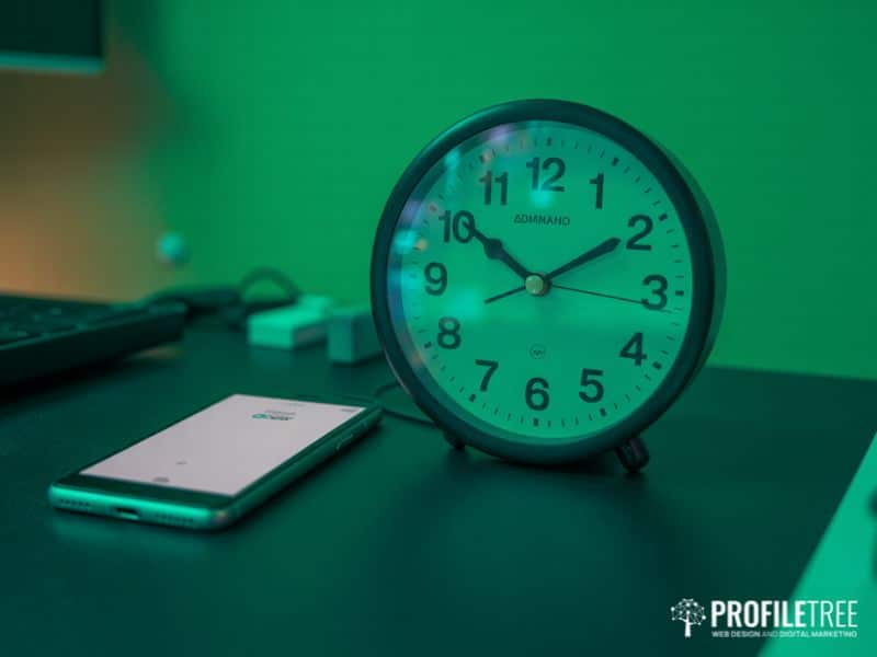 Clock and smartphone on a desk representing the critical first hour for social media identity theft recovery