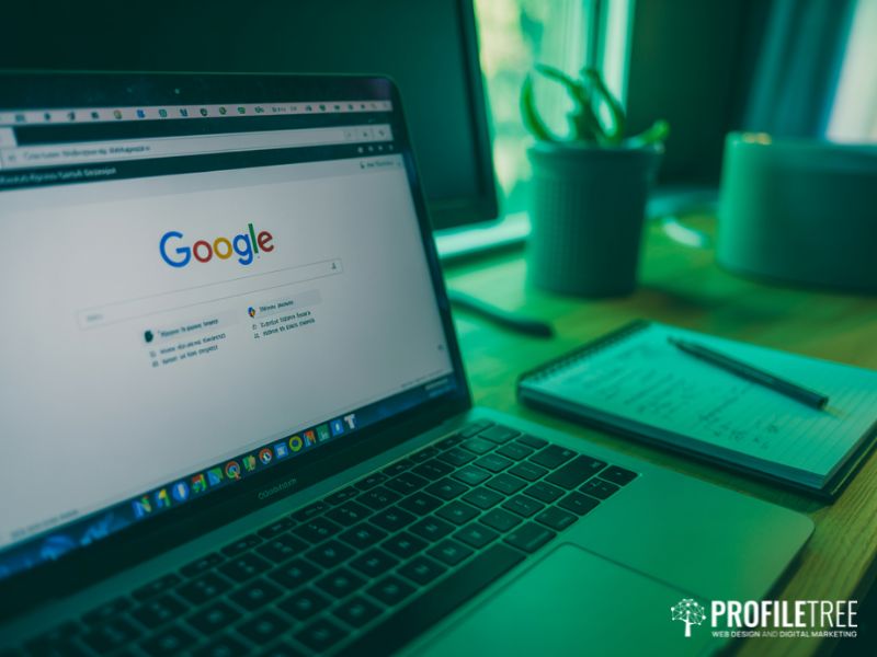 A laptop showing Google search results used alongside written notes as part of a keyword research tools workflow