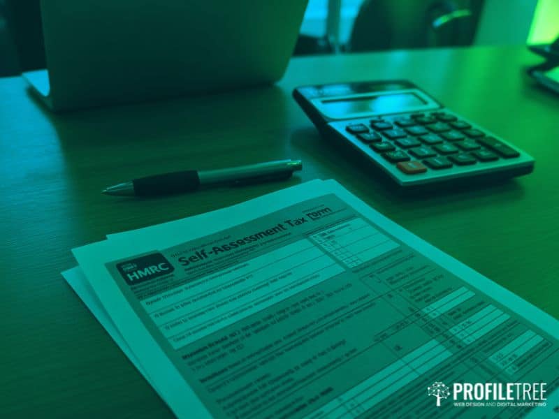HMRC self-assessment tax form on a desk, relevant to UK creators managing YouTube Monetisation income and tax obligations