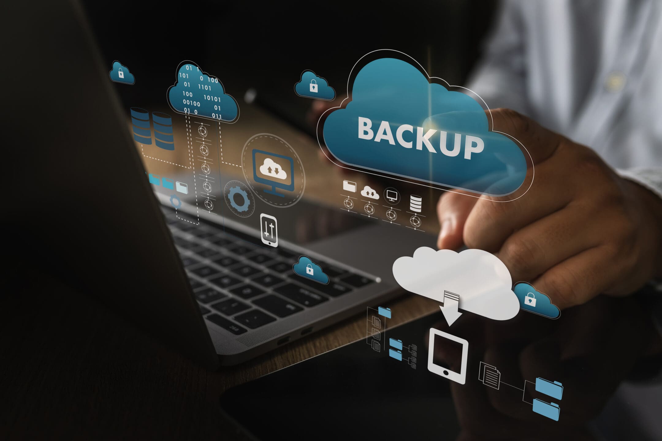 A person using a laptop to transfer data or access a cloud backup.