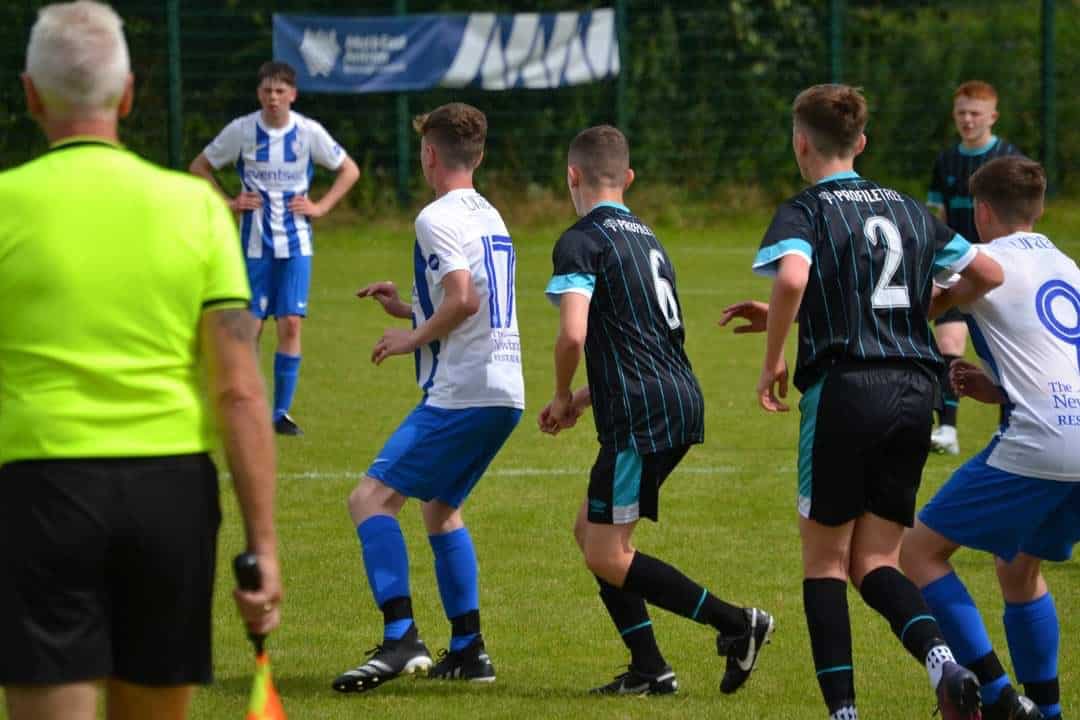 Photograph of Linfield Youth Team on Football pitch with ProfileTree branded jerseys