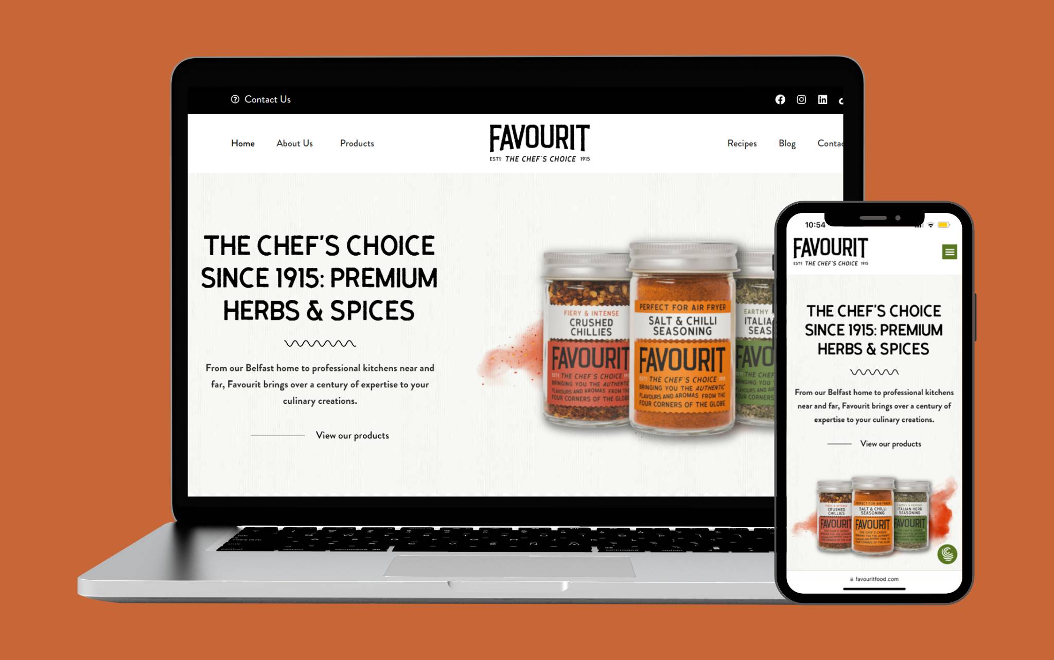 A laptop and smartphone display the Favourit heritage brand website design, featuring jars of herbs and spices and the headline The Chef’s Choice Since 1915: Premium Herbs & Spices on a white background with an orange accent.