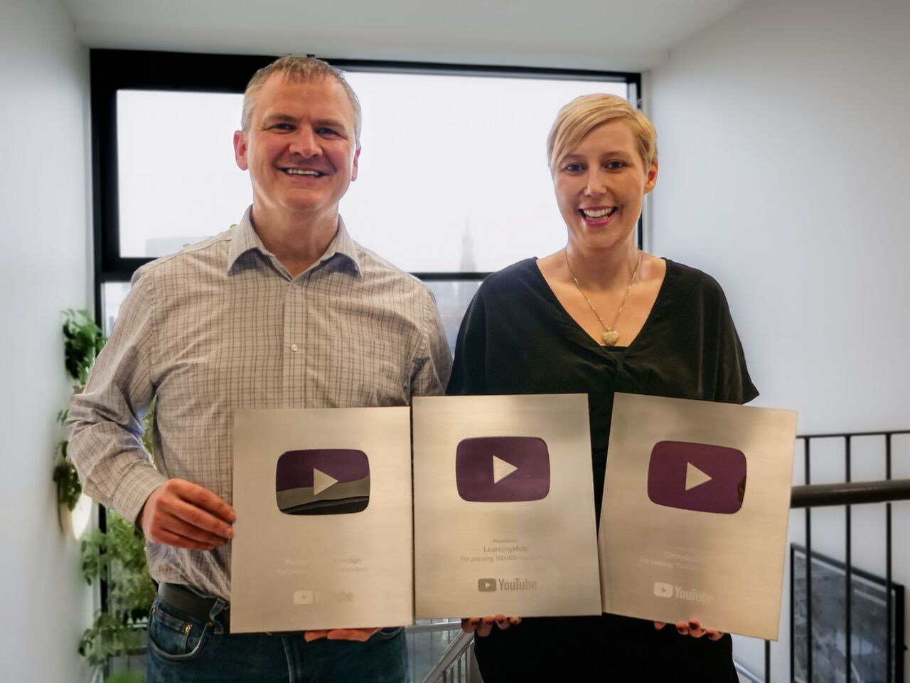 Ciaran and Michelle with three silver YouTube play buttons achieved for receiving over 100 thousand subscribers for three of their YouTube channels