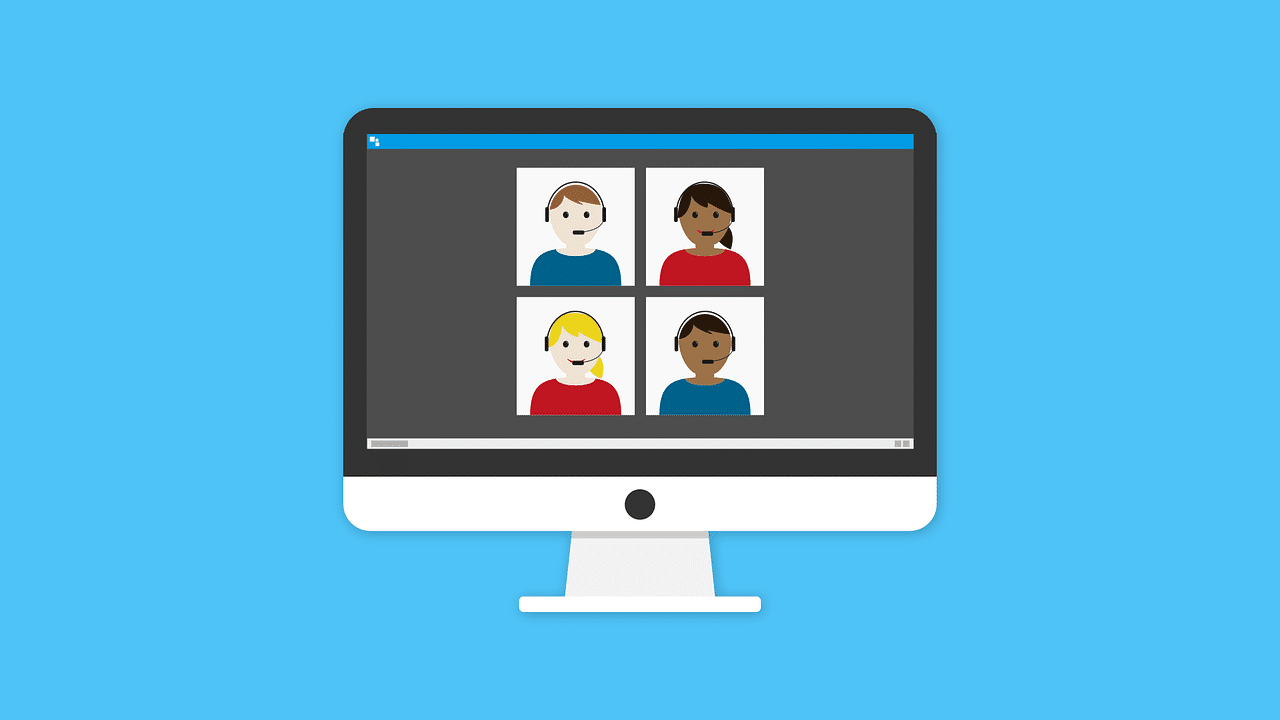 A computer monitor displays a video call with four illustrated people in separate squares, each wearing headphones, against a blue background.